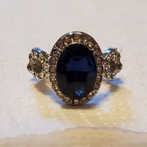 Paparazzi blue sapphire gemstone silver ring with diamond accents.